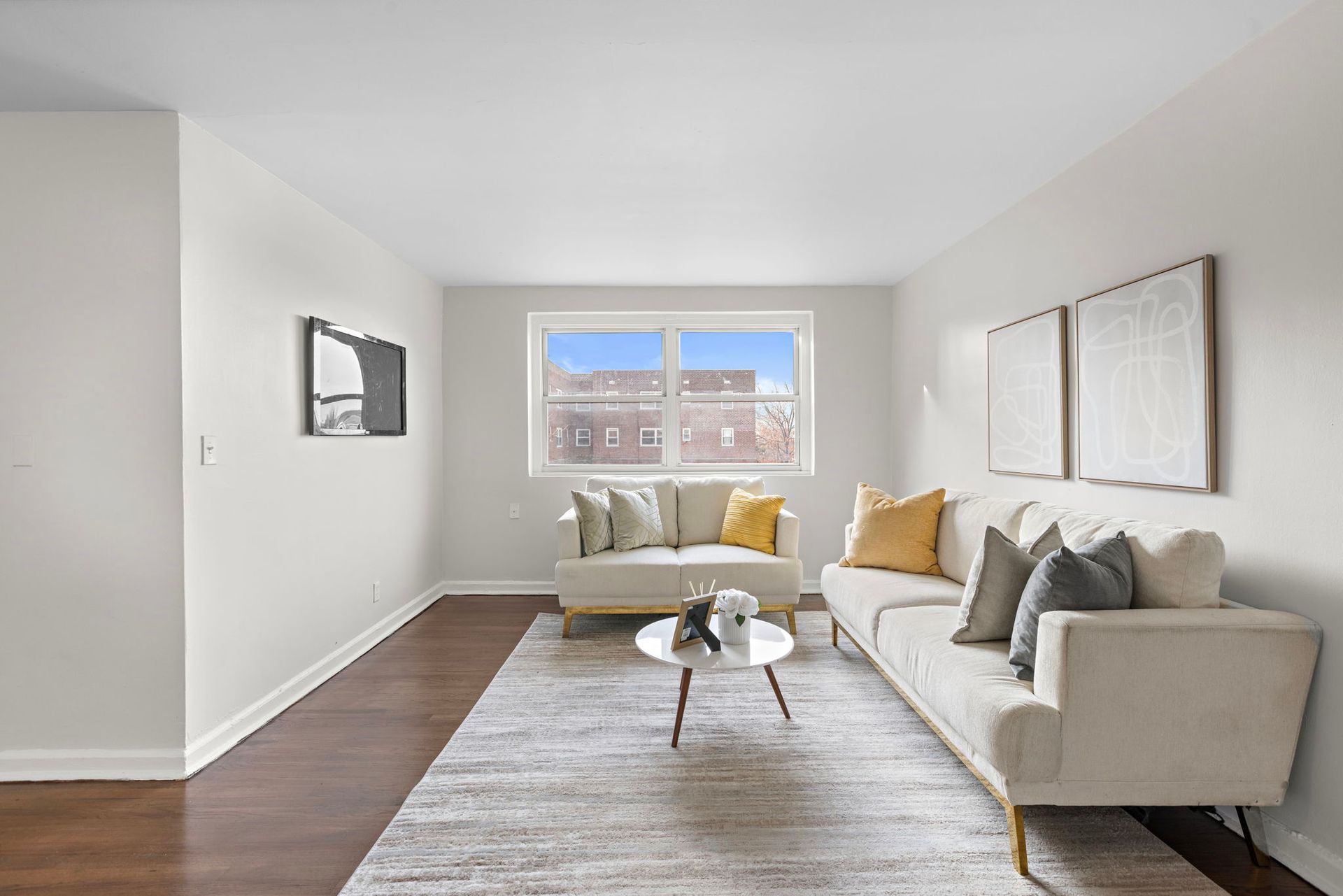 A living room with a couch , coffee table , and window.