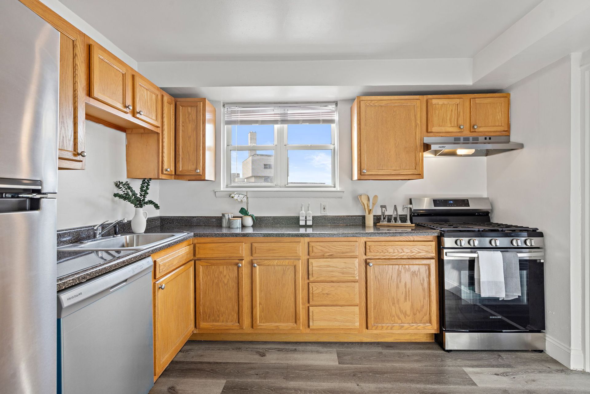 A kitchen with wooden cabinets and stainless steel appliances.