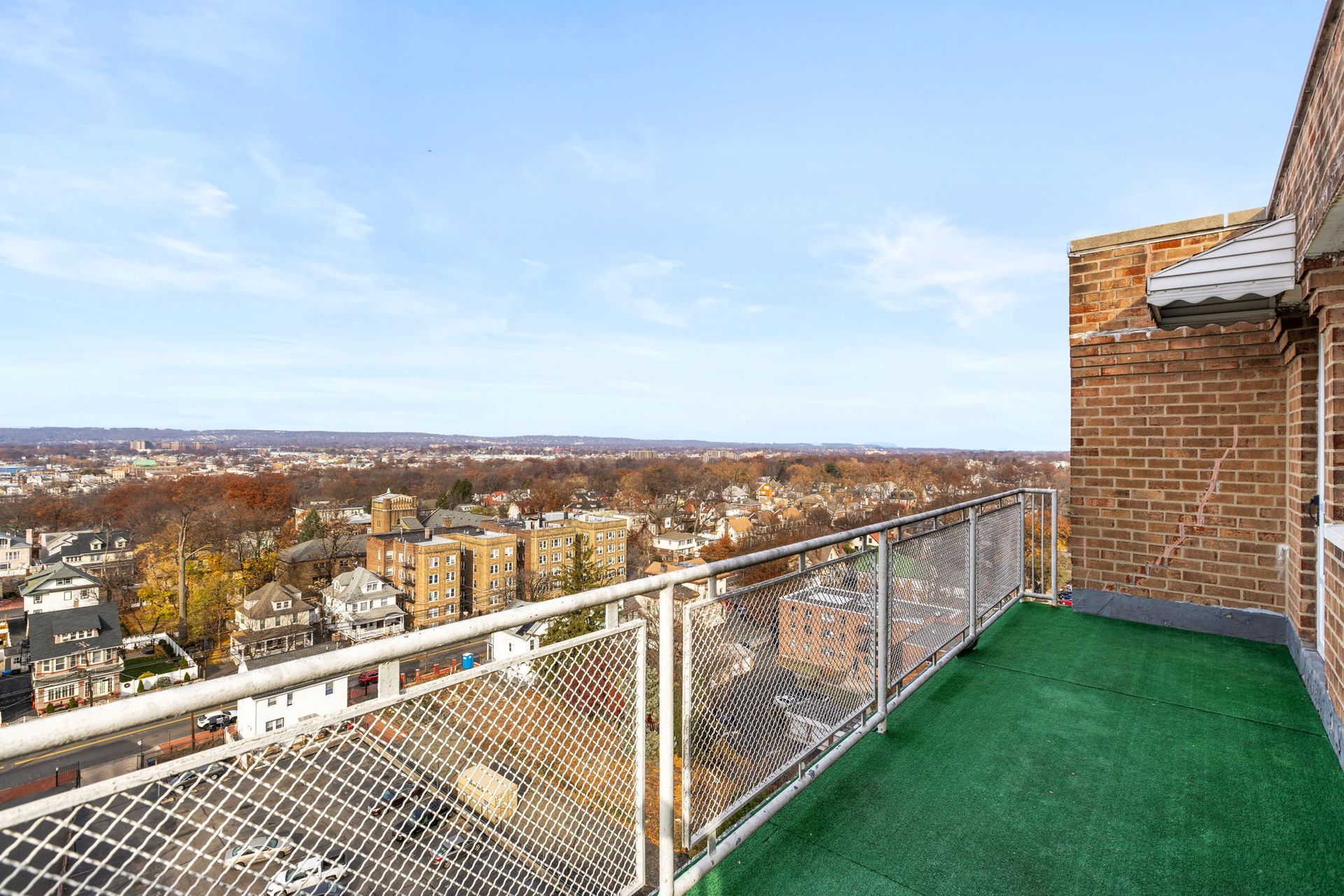 There is a balcony with a view of the city.