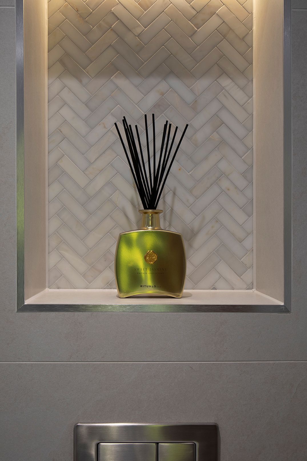 Herringbone marble niche with integrated LED lighting in Tewin spa bathroom