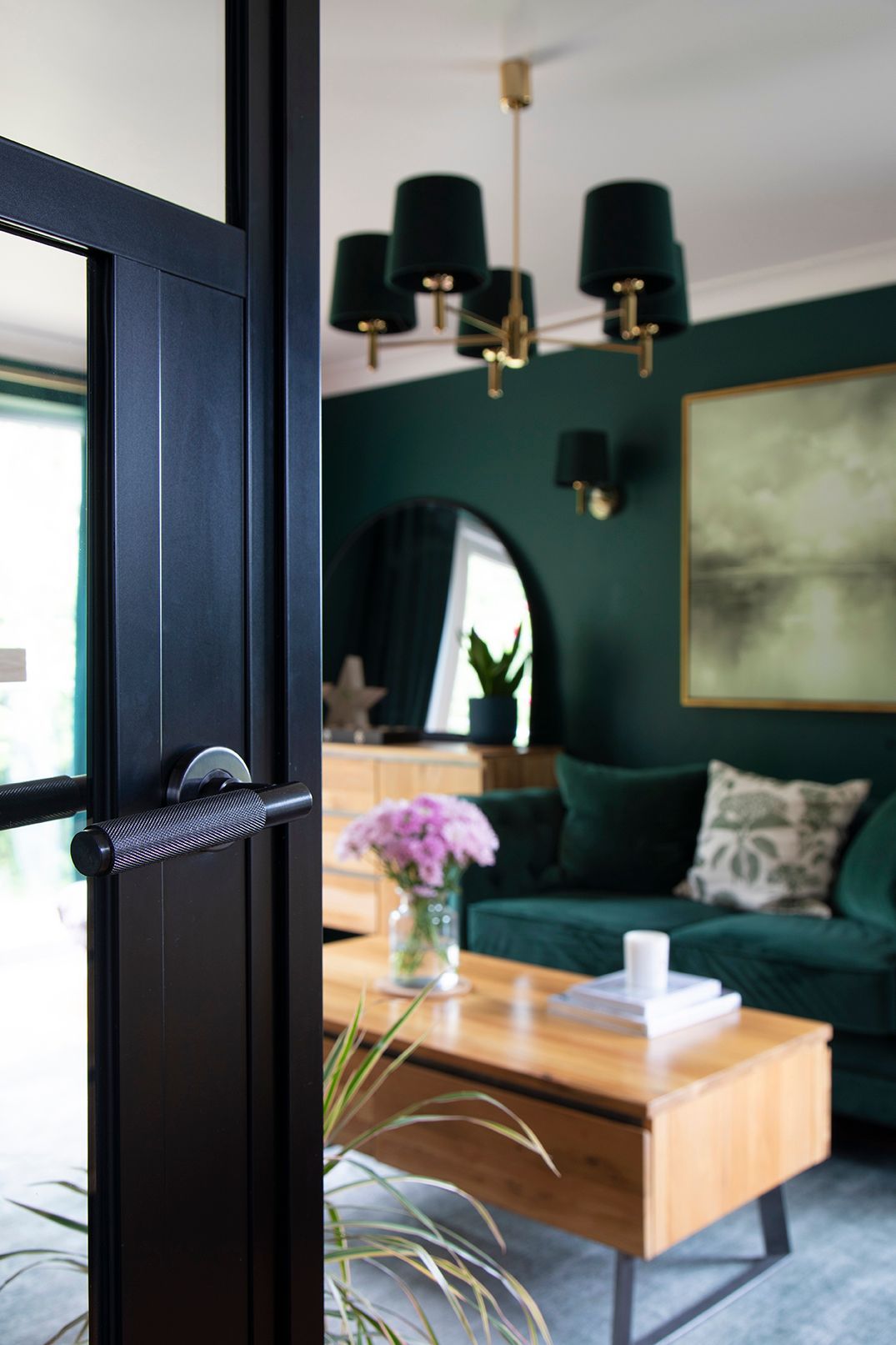 Black framed crittall door detail with brass handle in hunter green living room - Elisa Design Welwyn Garden City