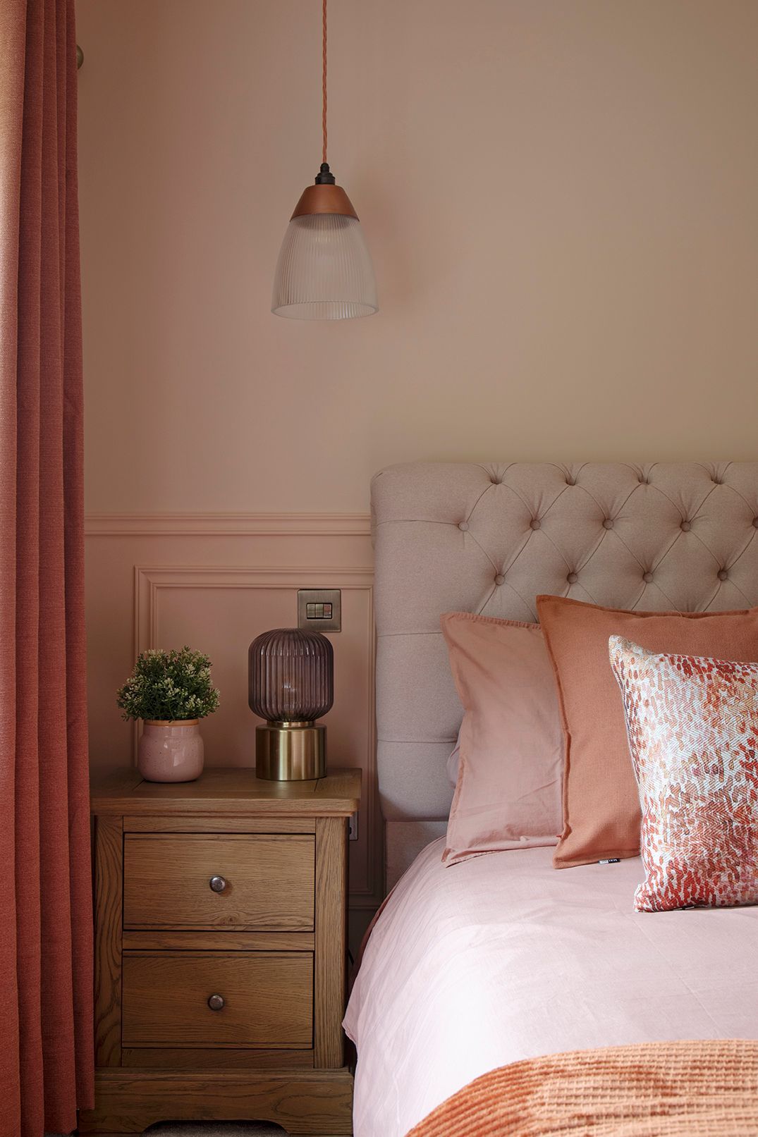 Bedside styling with brass cage table lamp, oak nightstand, and layered textiles in master bedroom - Elisa Design
