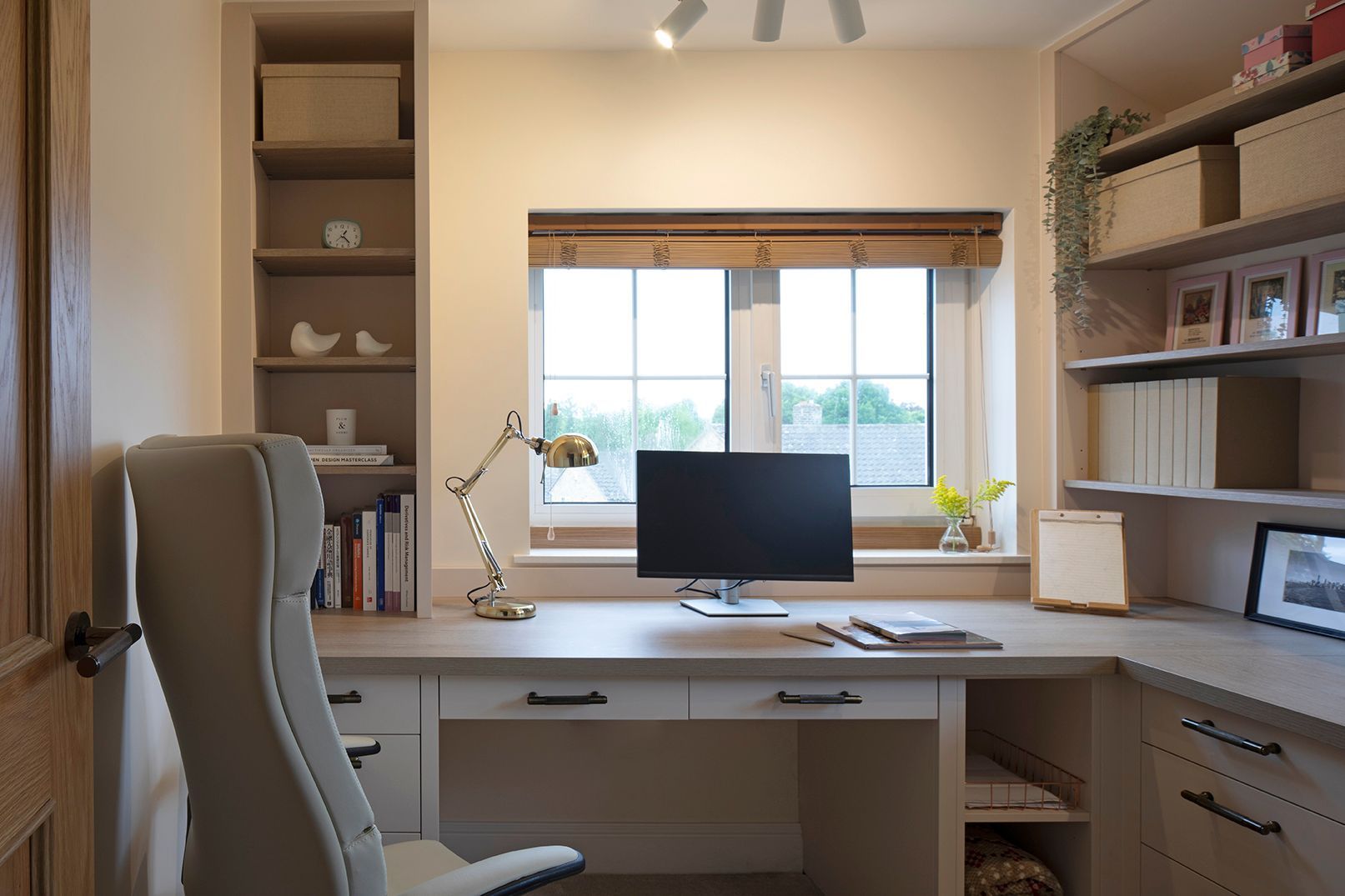 Front view of bespoke L-shaped home office desk with oak finish and brass hardware - Elisa Design Welwyn Garden City