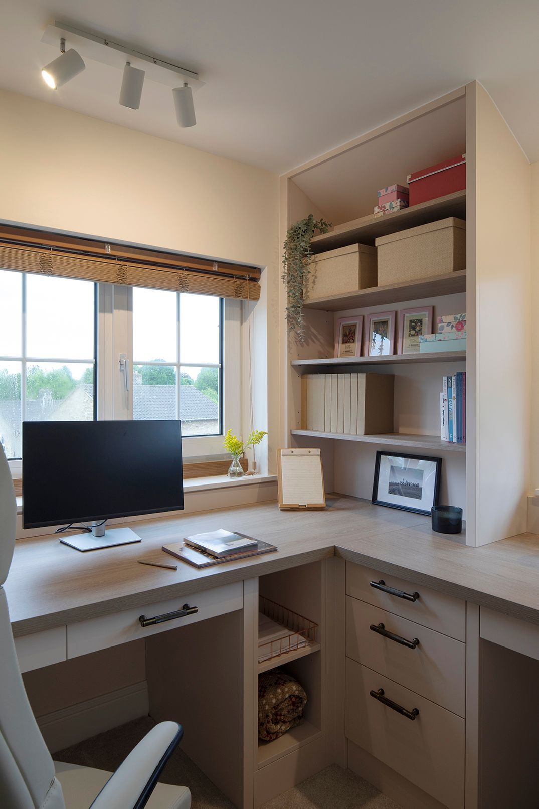 Bespoke L-shaped home office desk with custom oak joinery and brass handles in Welwyn Garden City home by Elisa Design