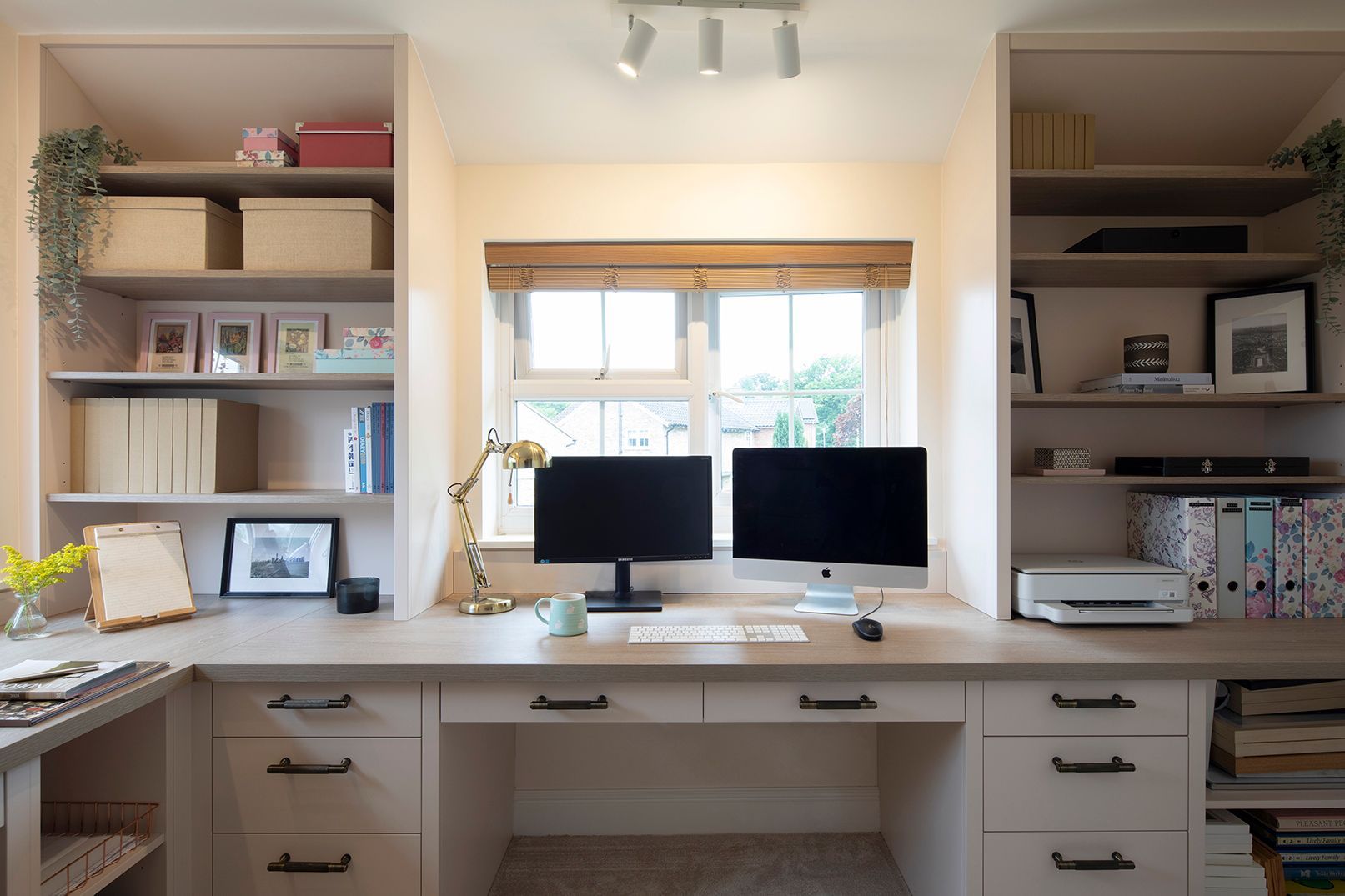 Custom home office desk with dual monitors, oak shelving, and brass task lighting - Elisa Design bespoke joinery