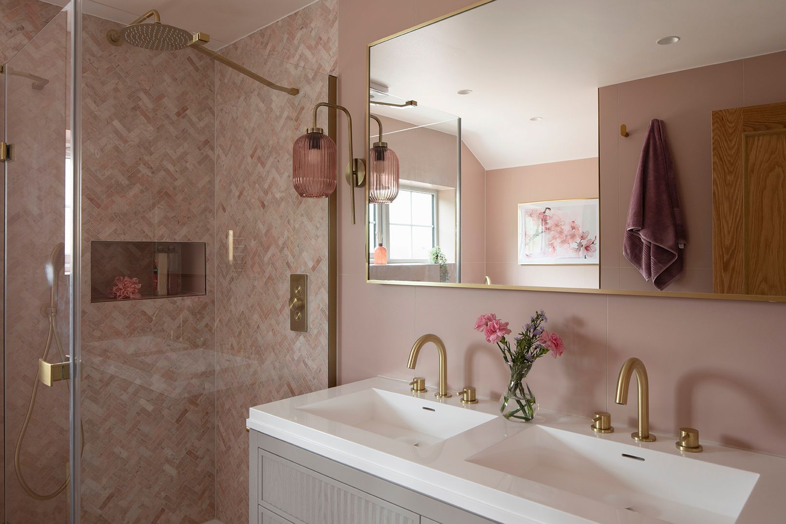 Luxury bathroom shower with herringbone stone tiles, brass rainfall head, and LED-lit niche - Elisa Design Welwyn Garden City