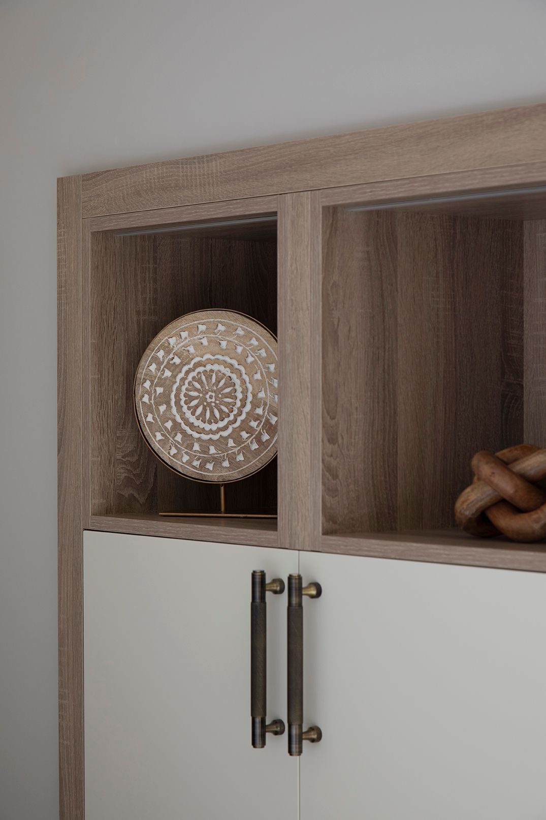 Bespoke LED-lit display cabinet with decorative ornament detail in Bushey loft bedroom by Elisa Design