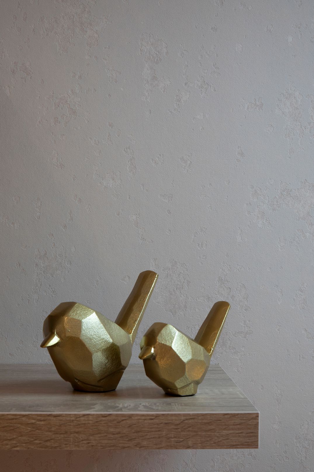 Brass decorative bird ornaments on floating oak shelf in Bushey loft workspace by Elisa Design