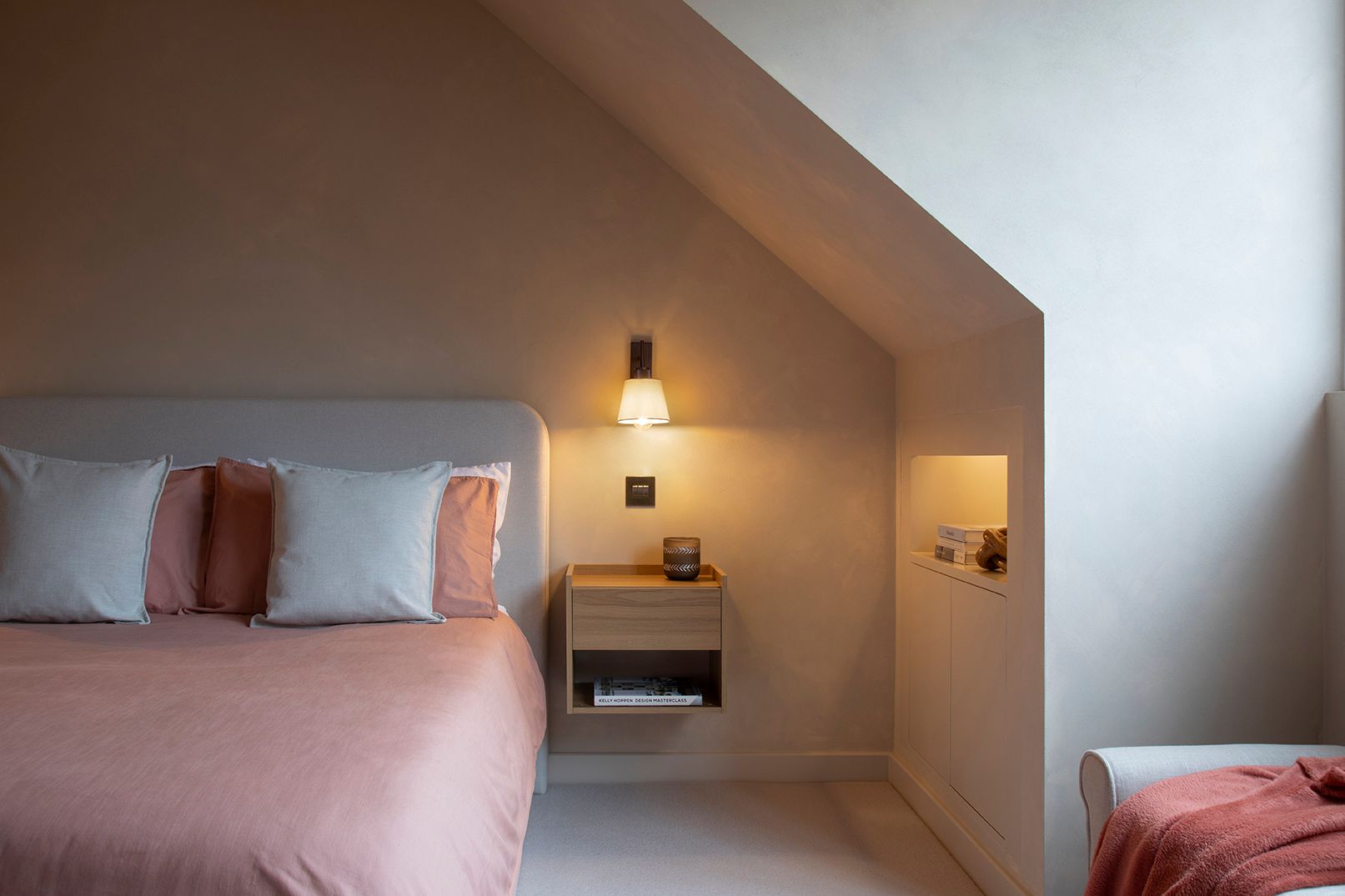 Luxury loft bedroom with soft limewash walls and warm ambient lighting in Watford sanctuary suite by Elisa Design