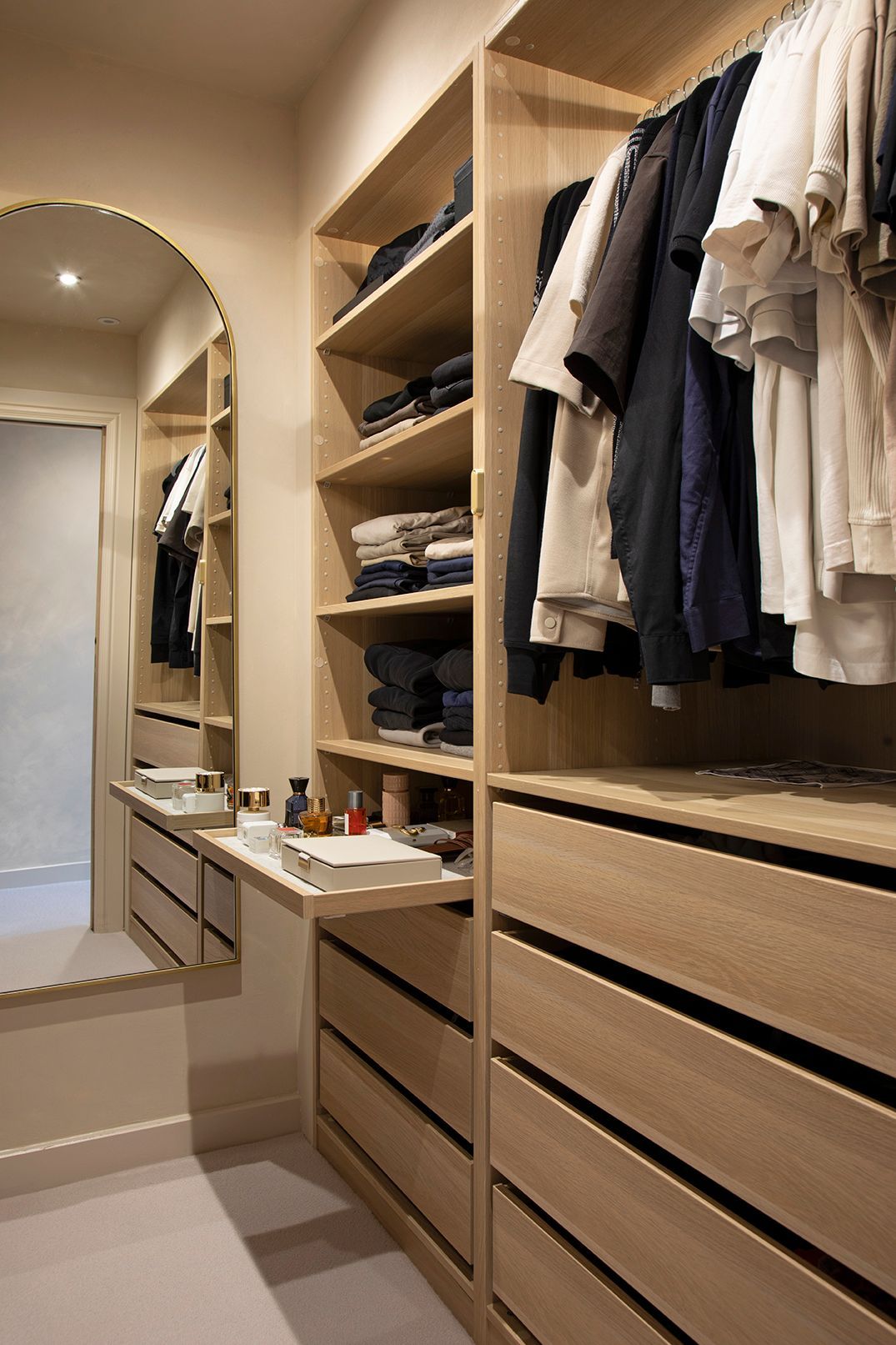 Luxury dressing area with brass-framed mirror, LED lighting, and oak storage in Watford loft