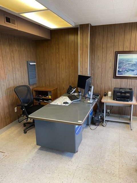 a desk with a computer and a printer on it