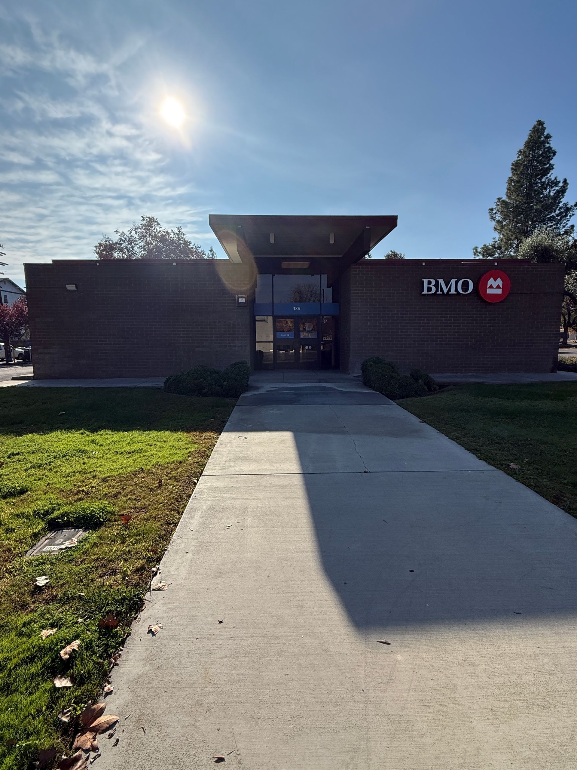 BMO bank exterior on a sunny day with a concrete path leading to the entrance.