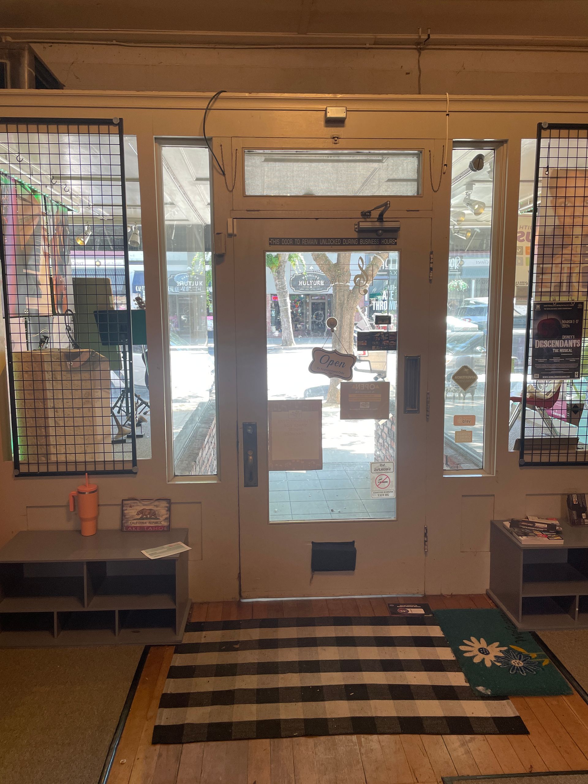 A room with a striped rug in front of a door
