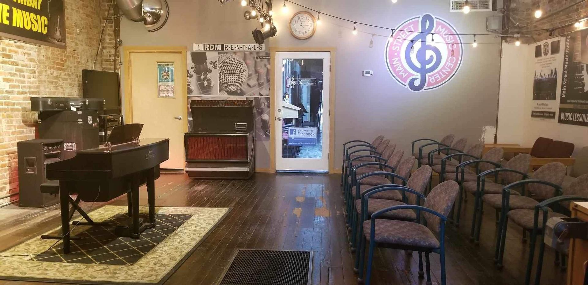 A room with a piano and chairs in it.