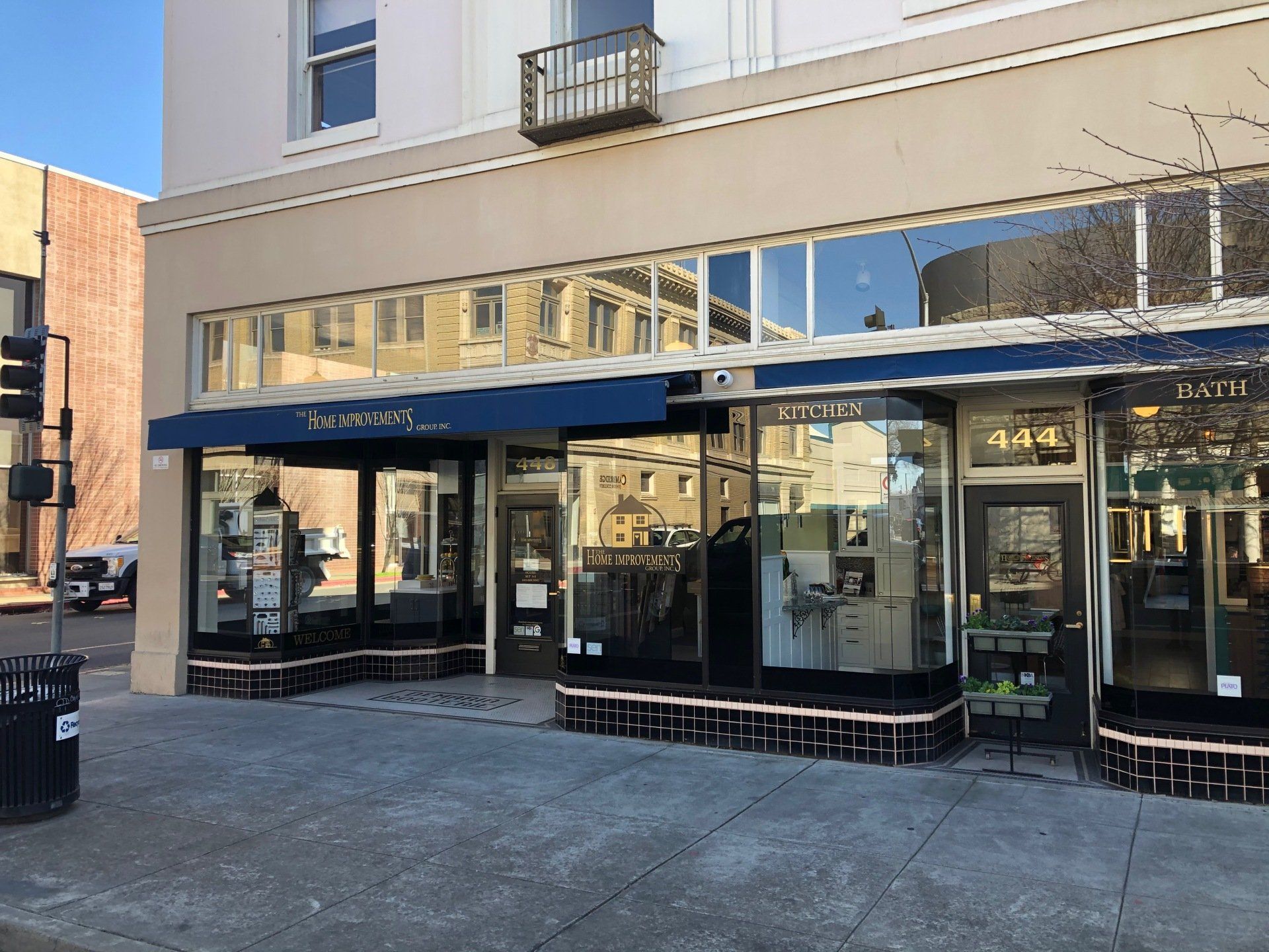 The front of a building with a blue awning on it