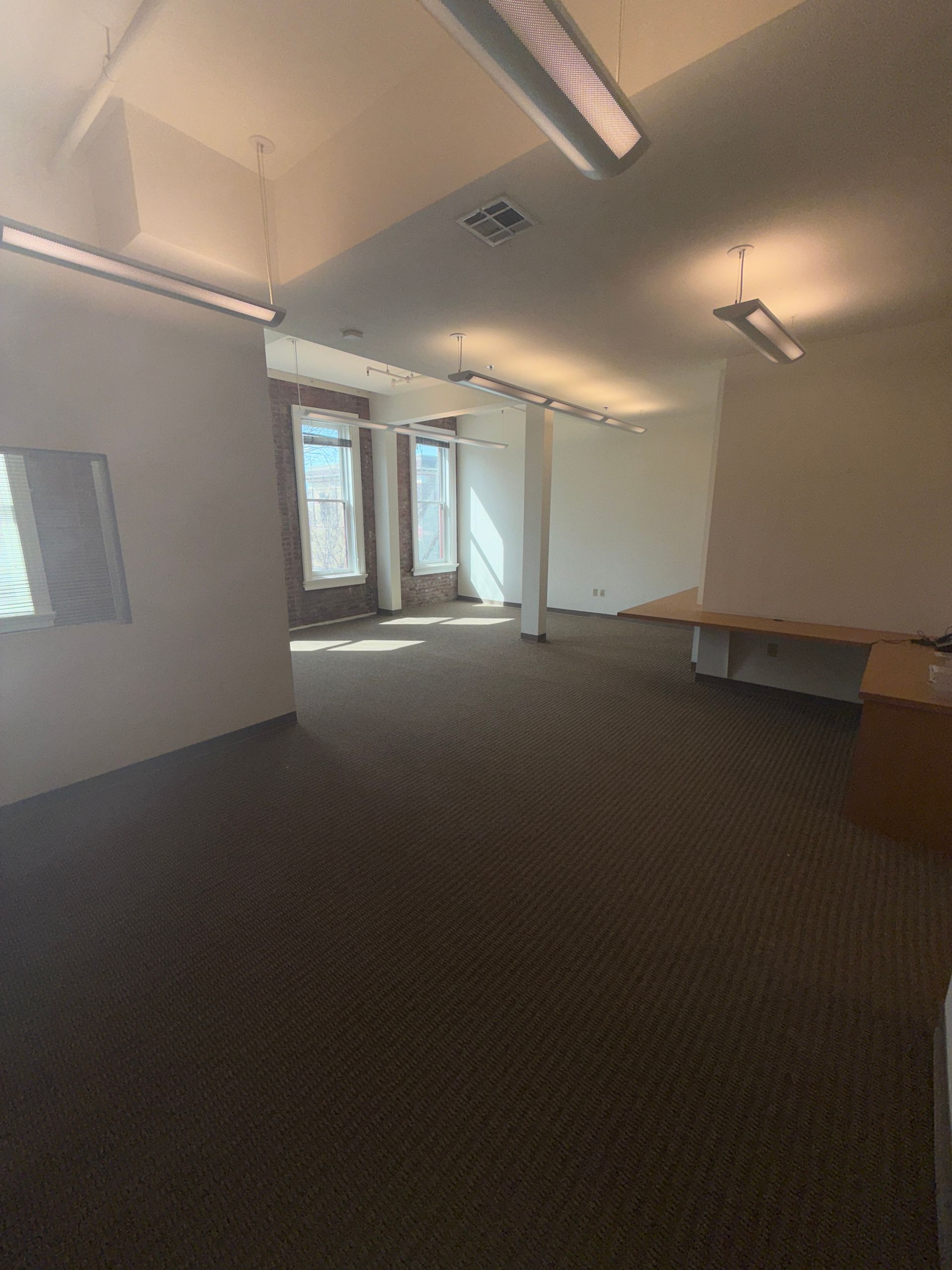 A large empty room with a lot of windows