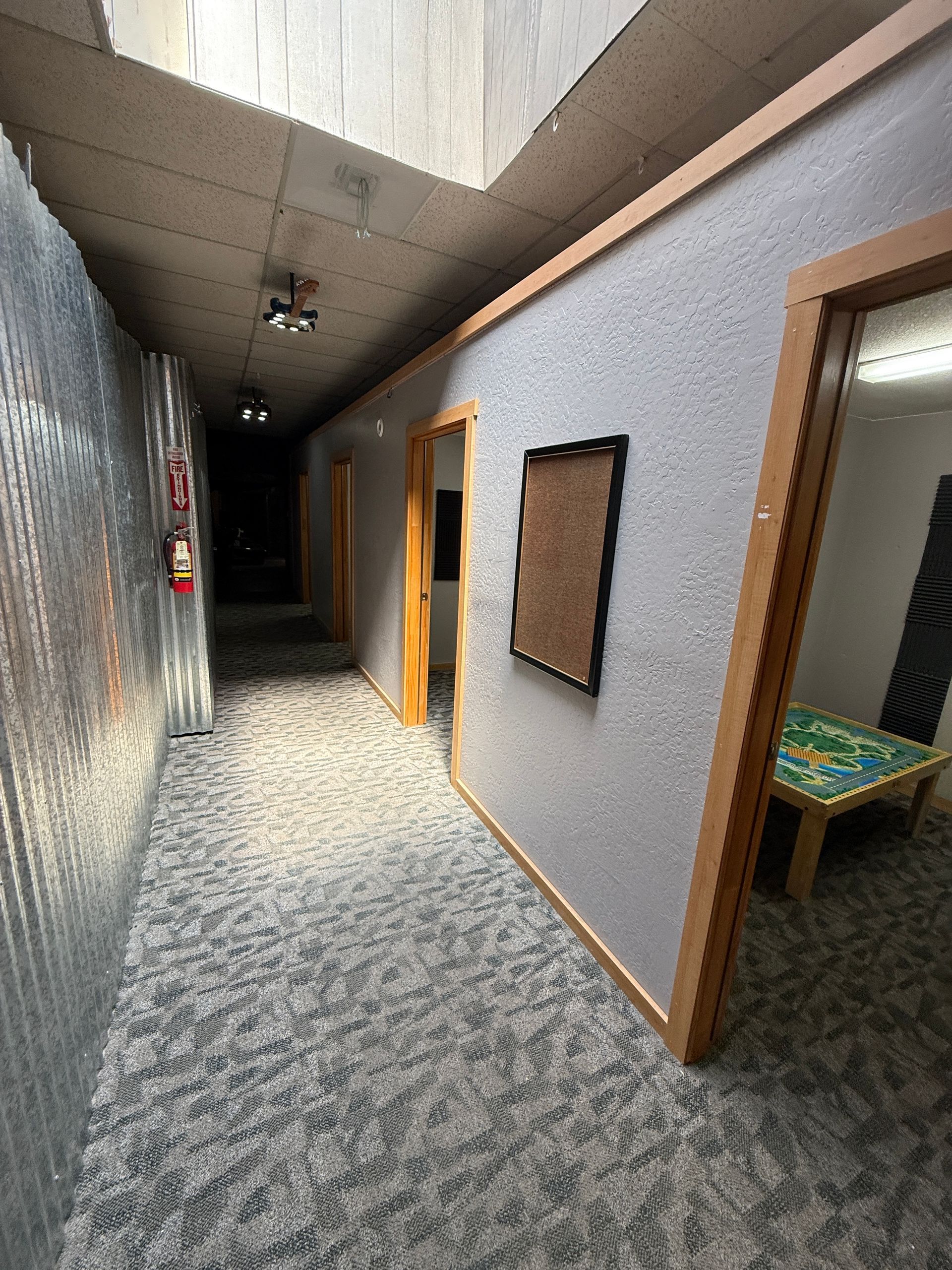 A long hallway with a table in the middle of it.