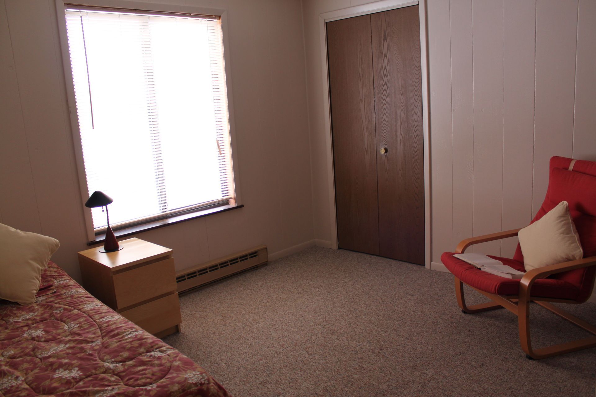 Photo showing a bedroom with a tall window