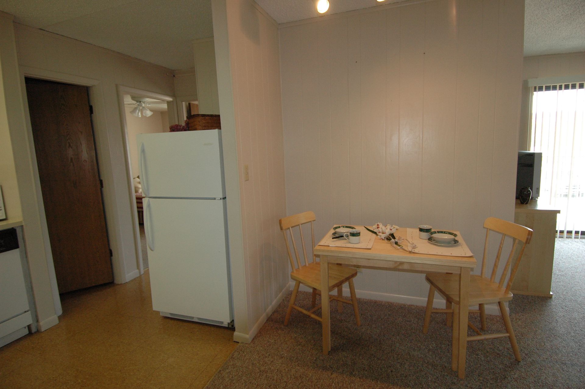Photo showing a refrigerator next to a dining table
