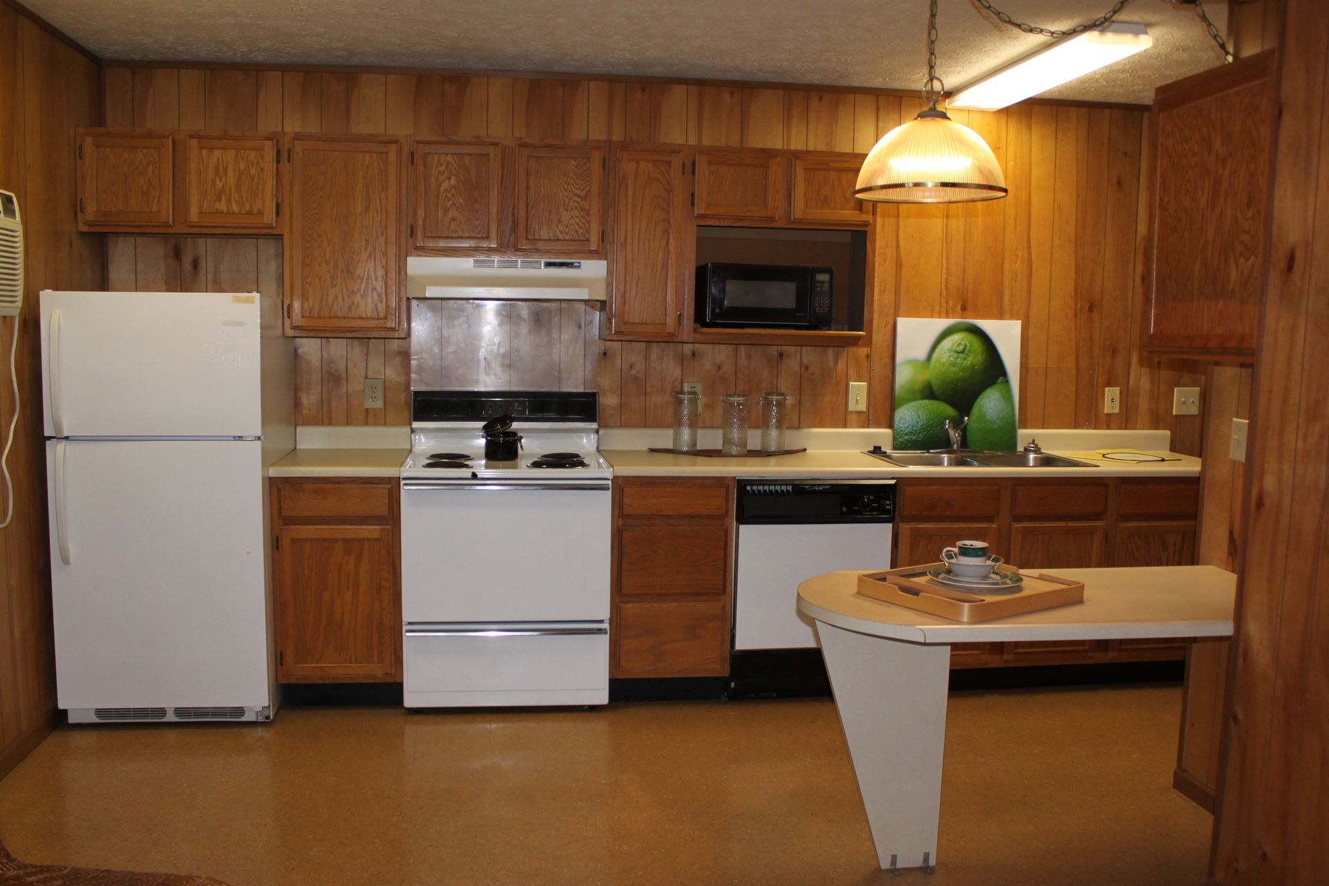 Photo showing a kitchen with the appliances and counters laid out in a straight line