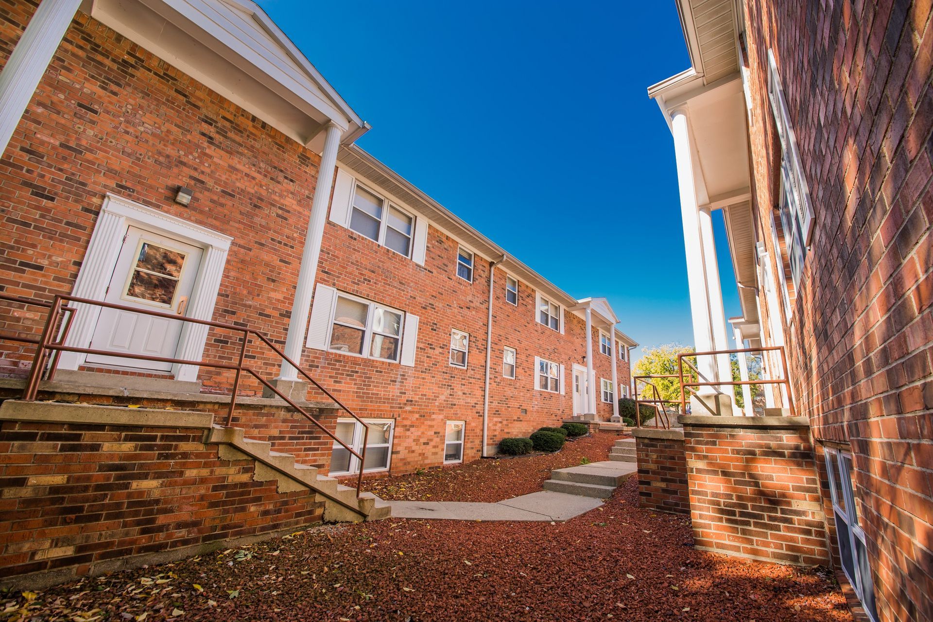 Photo showing a pair of buildings from behind one of the buildings