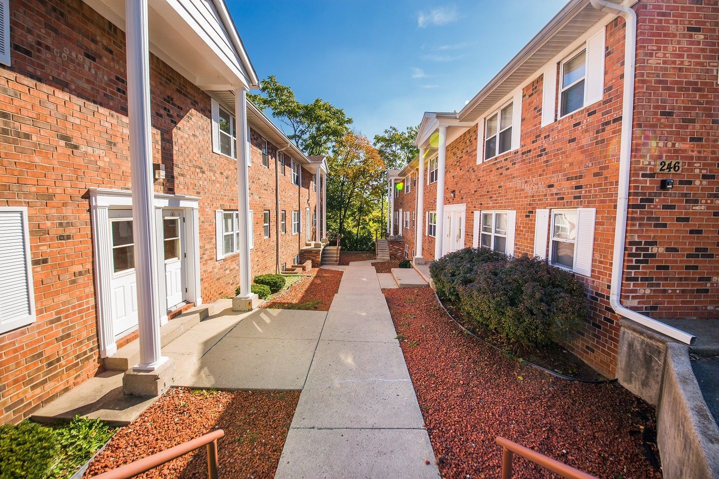 Photo showing a walking space between 2 brick buildings