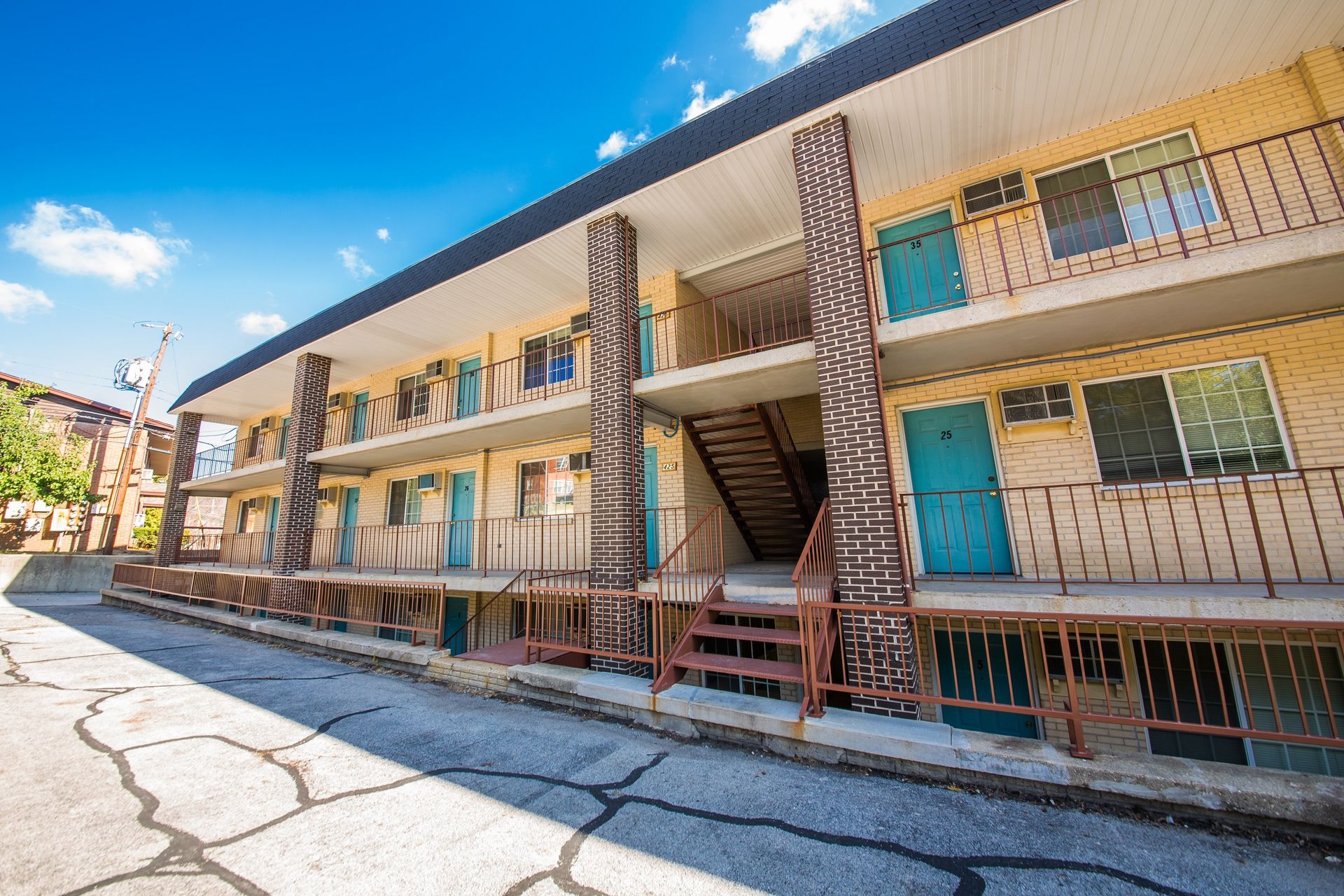 Photo showing a 3 story building from in front of the steps but closer up