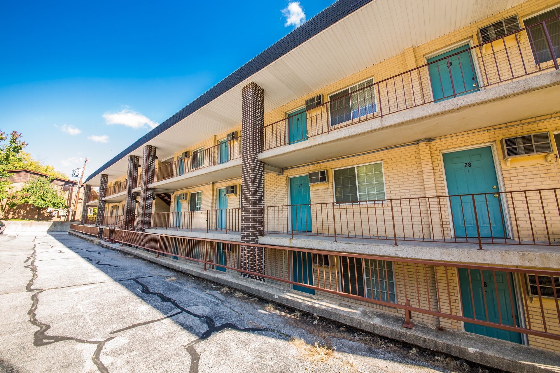 Photo showing a 3 story building from an angle showing the length of the building