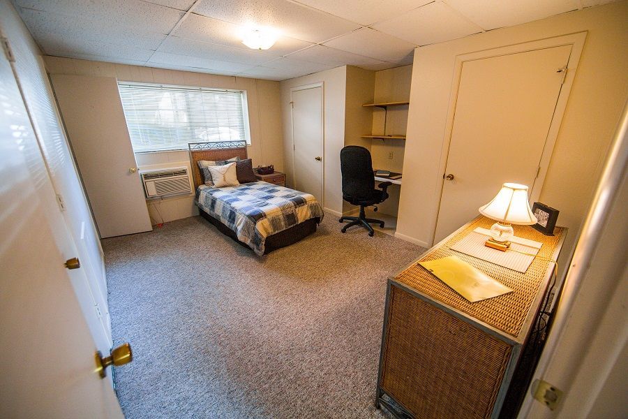 Photo showing a bedroom with a built-in desk area