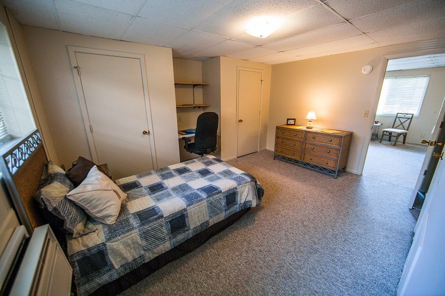 Photo showing a bedroom with a living room in the background