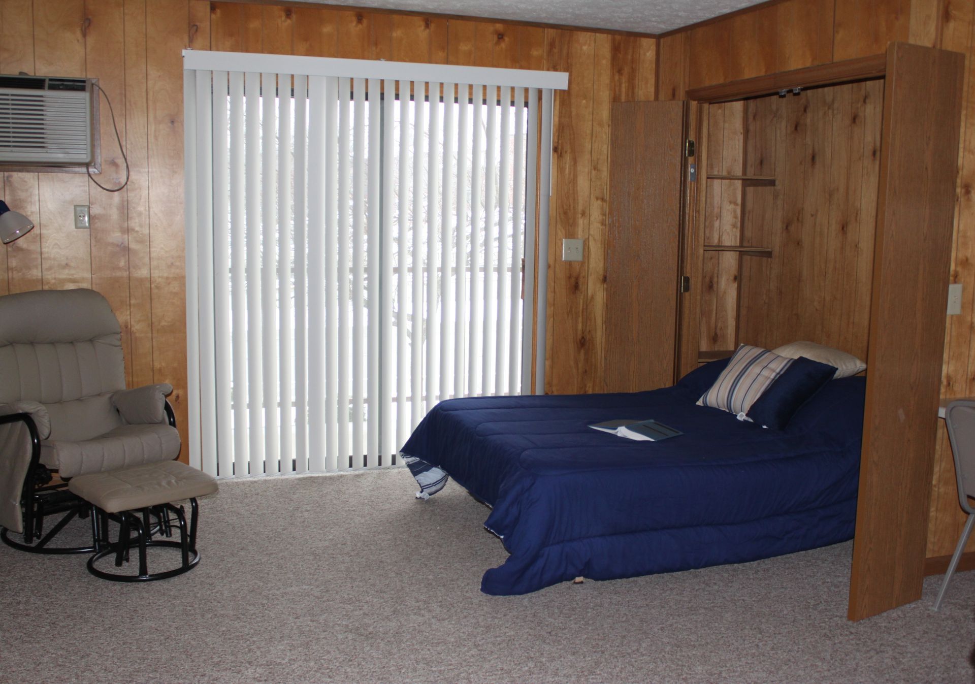 Photo showing a wall bed and a chair