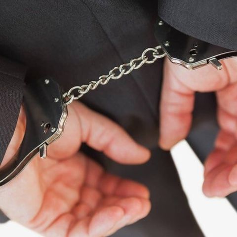Business criminal with handcuffs - Lawyer in Milwaukie, OR
