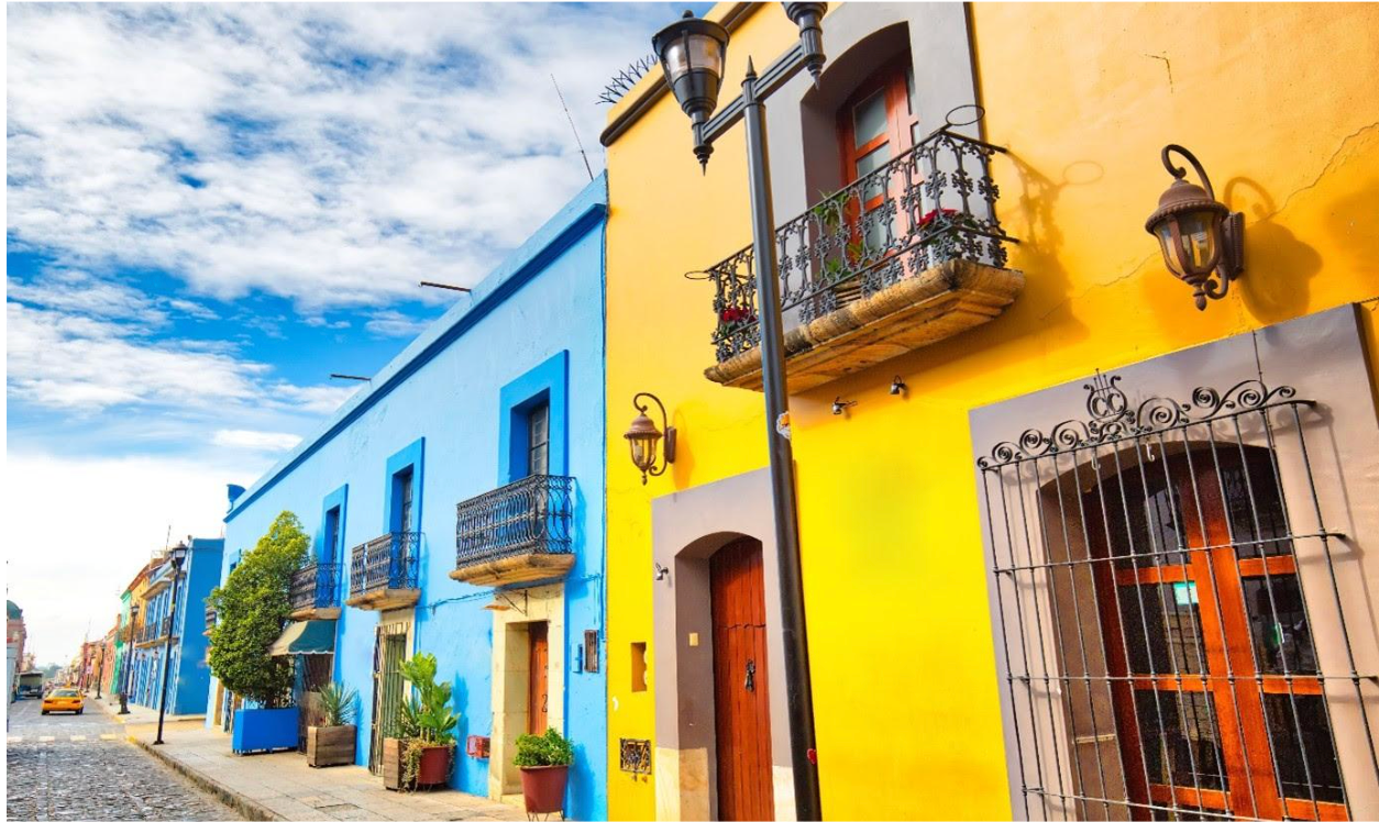 A row of colorful buildings on a cobblestone street.