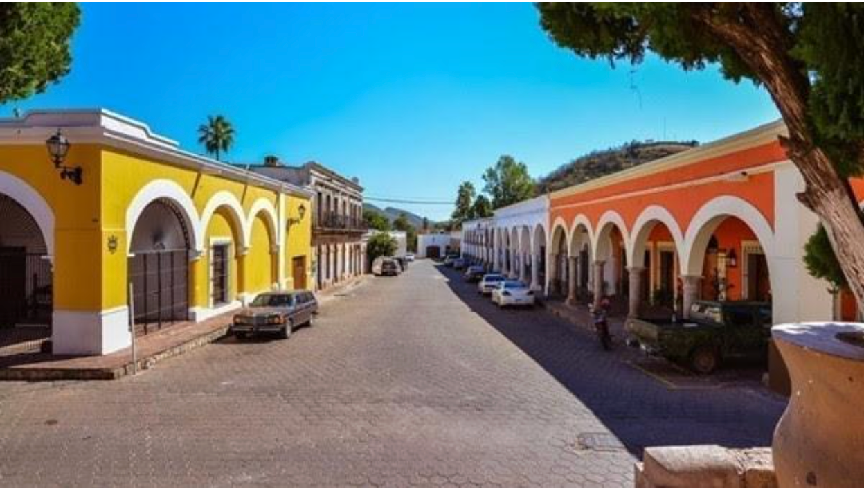 A row of yellow and orange buildings on a street