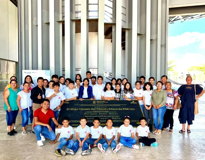 A group of people are posing for a picture in front of a building.