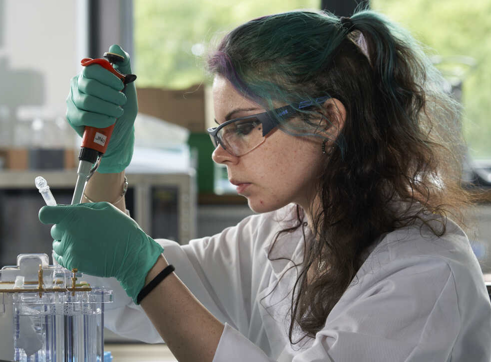 Scientist holding an ALiCE cell-free protein expression kit