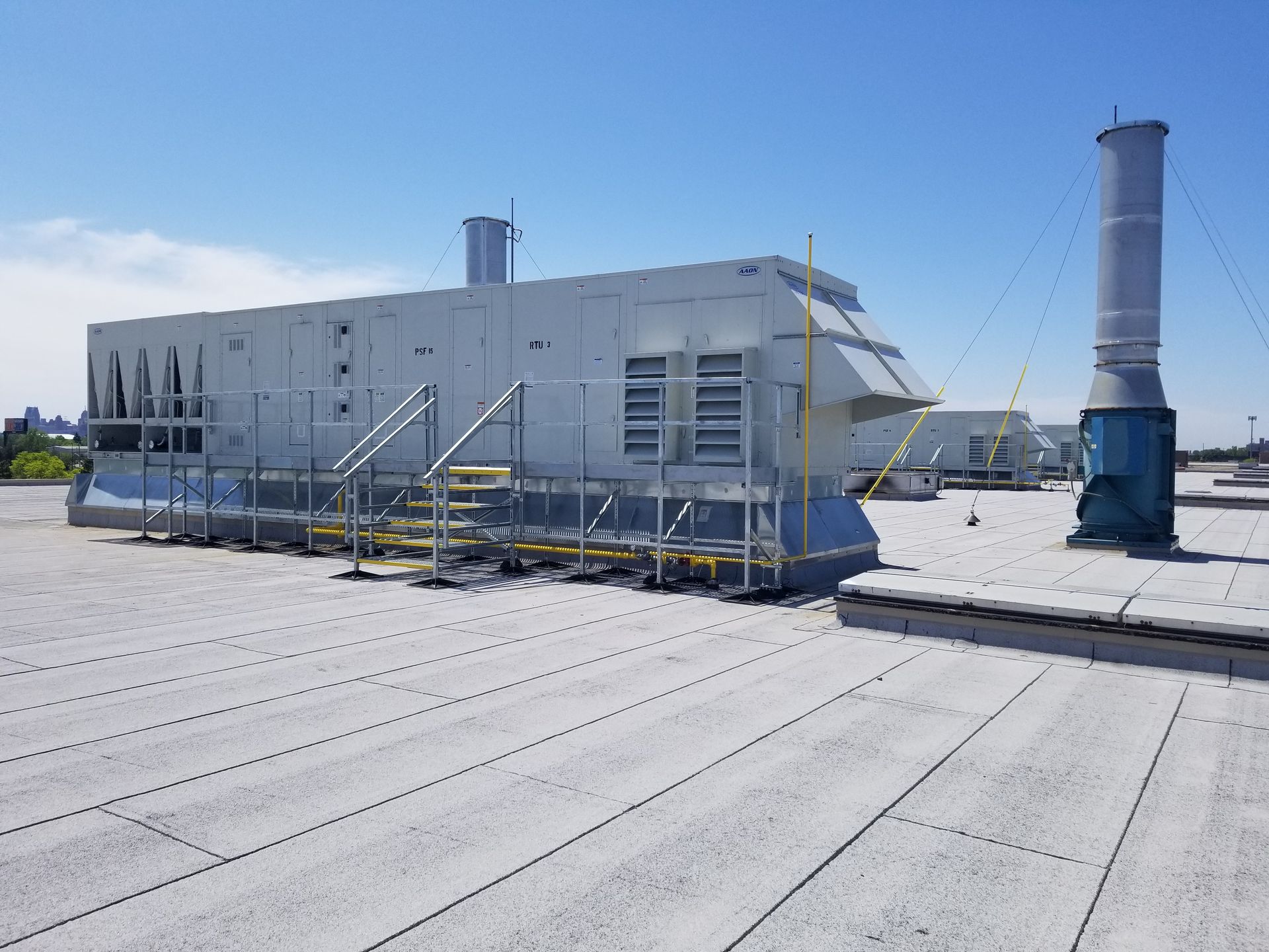 A large white box is sitting on top of a snow covered roof.