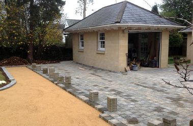 A small house with a slate roof is being built.