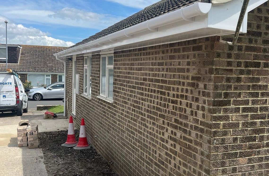 A brick house with a white van parked in front of it.