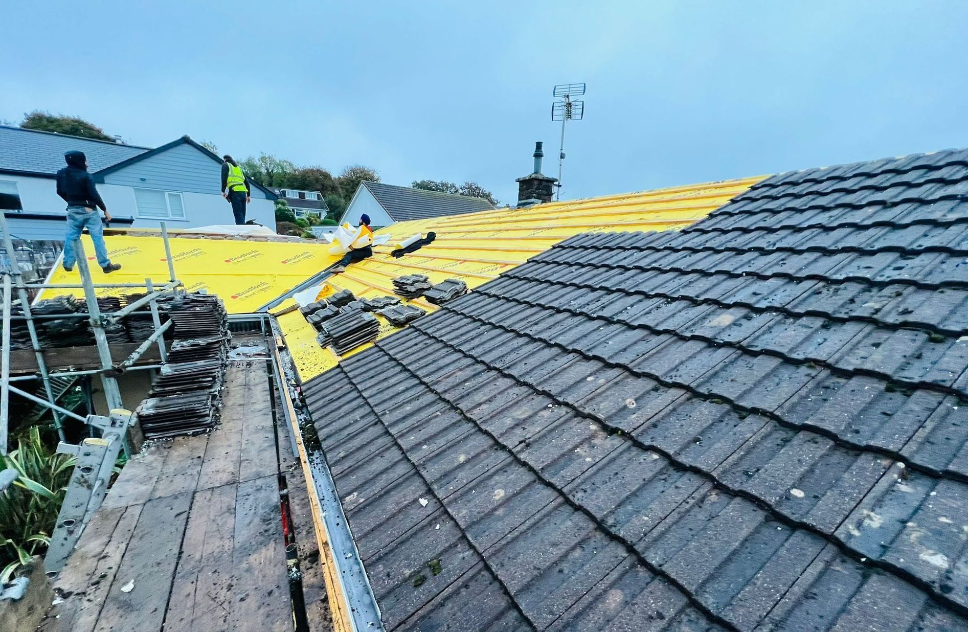 A roof with a lot of tiles on it is being built.