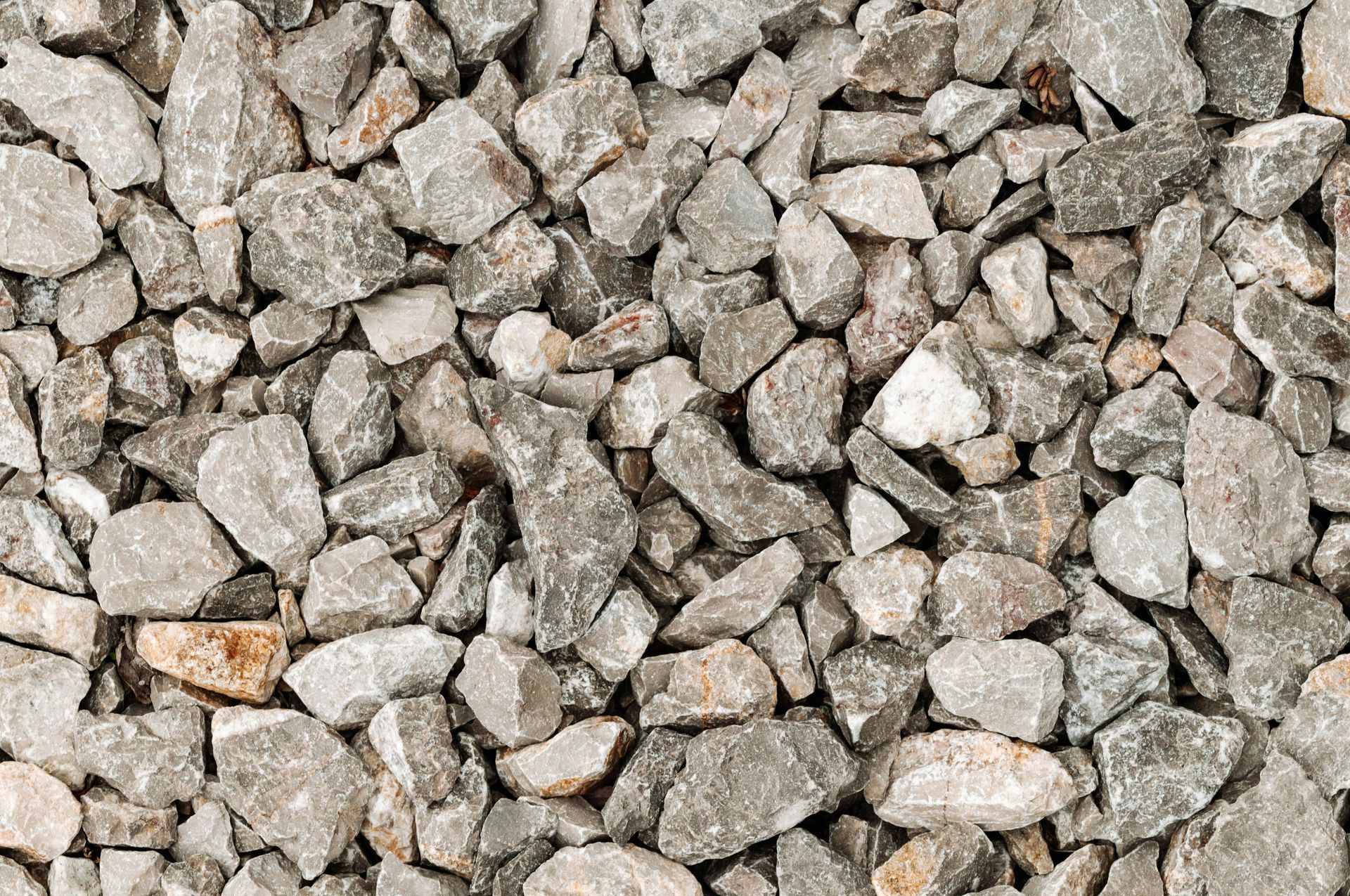 A pile of gravel is sitting on the ground.