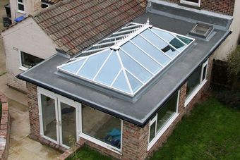 An aerial view of a house with a skylight on the roof.