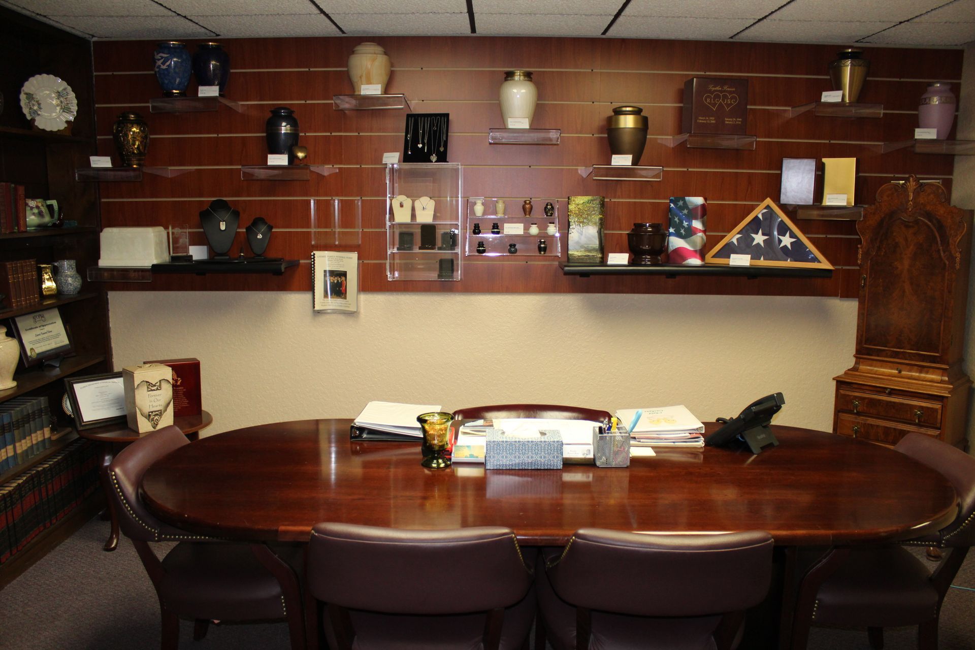 A conference room with a large wooden table and chairs