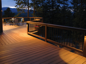 A deck with a table and chairs on it at night