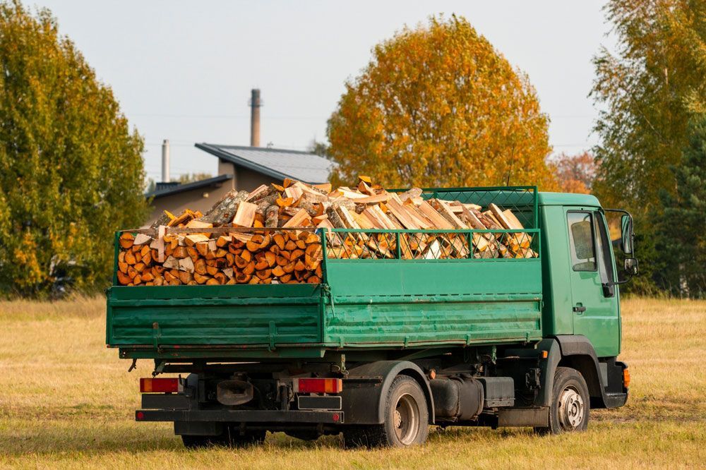 Dump truck with a body full of firewood — Mulch in Wollongong, NSW