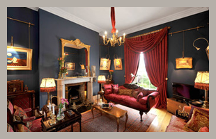 Living room with black walls and antique furniture 