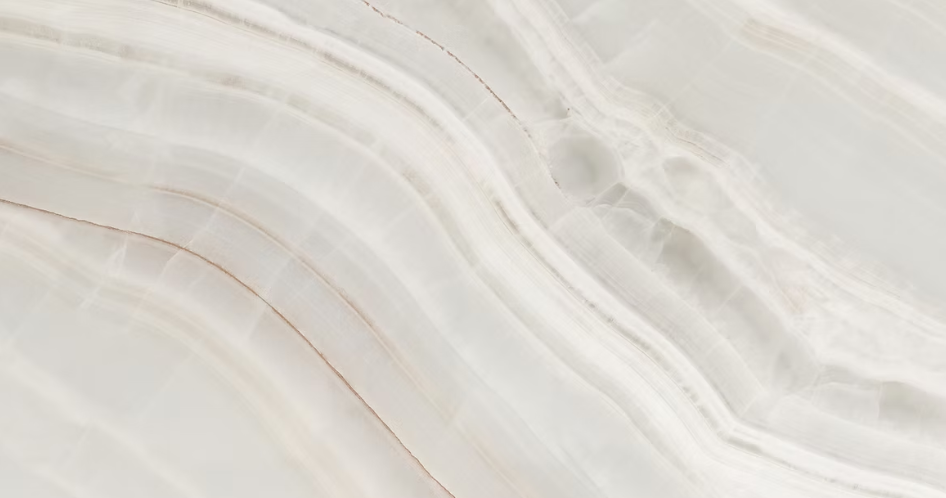 White marble with flowing, wavy patterns and subtle tan veining.