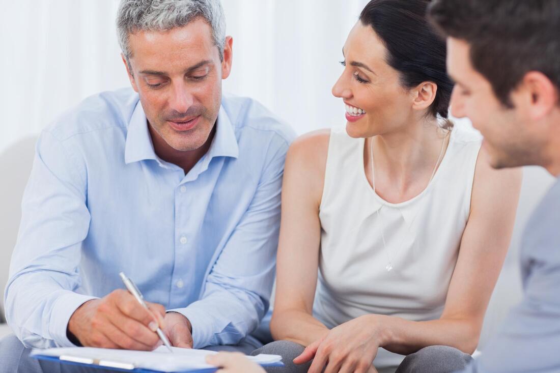 Man showing documents to a couple