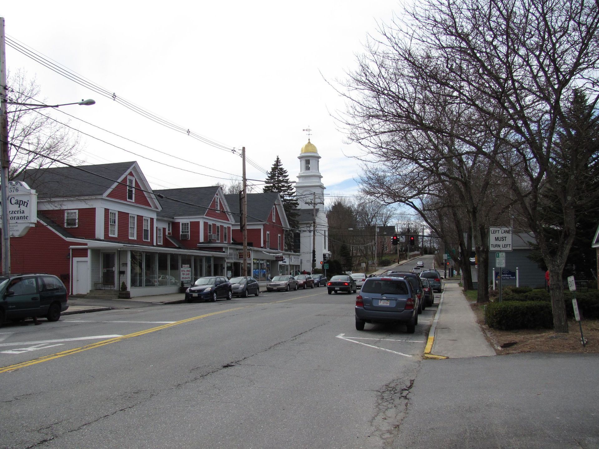 A small town street with a church in the background