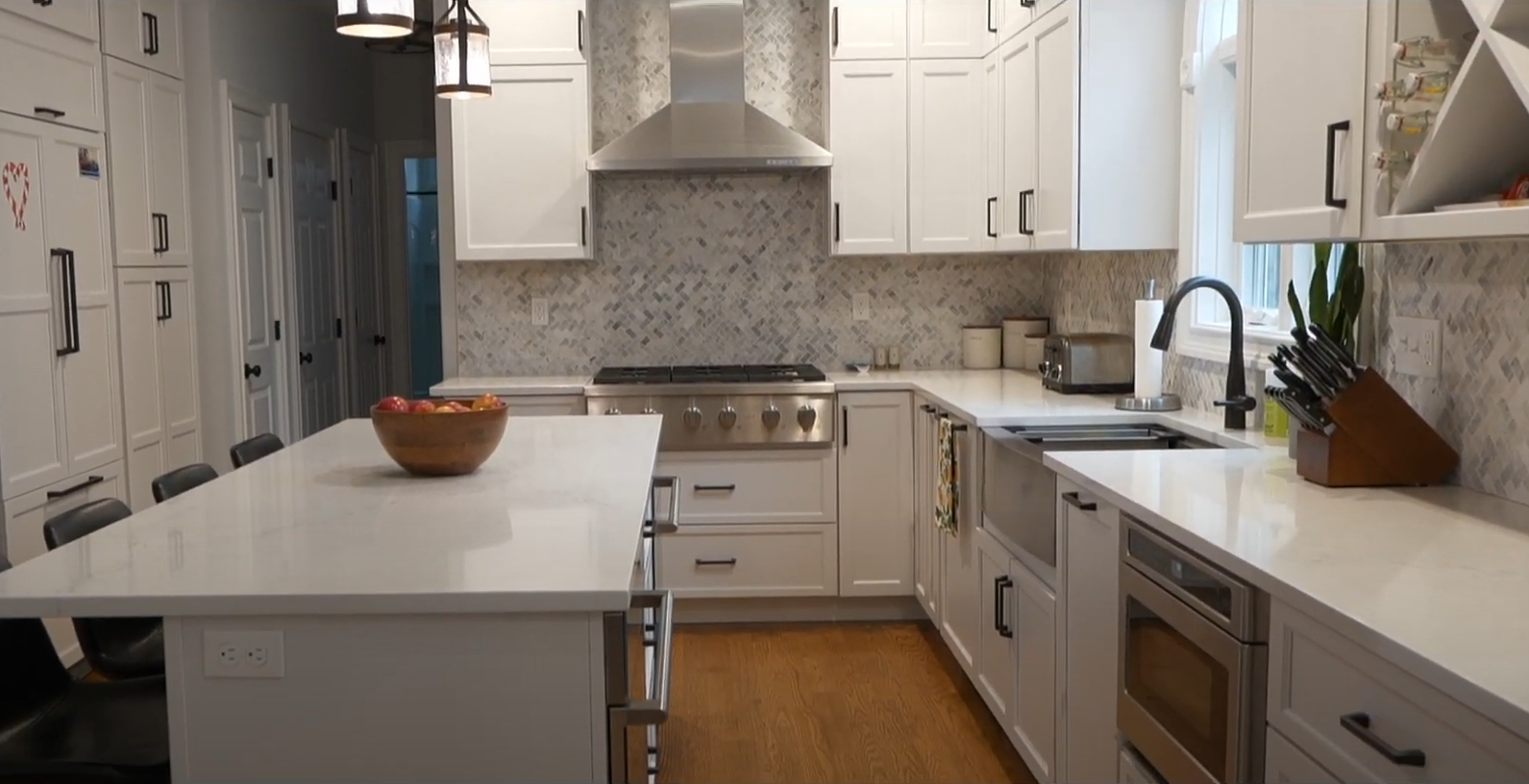 A woman and a man are standing next to each other in a kitchen.